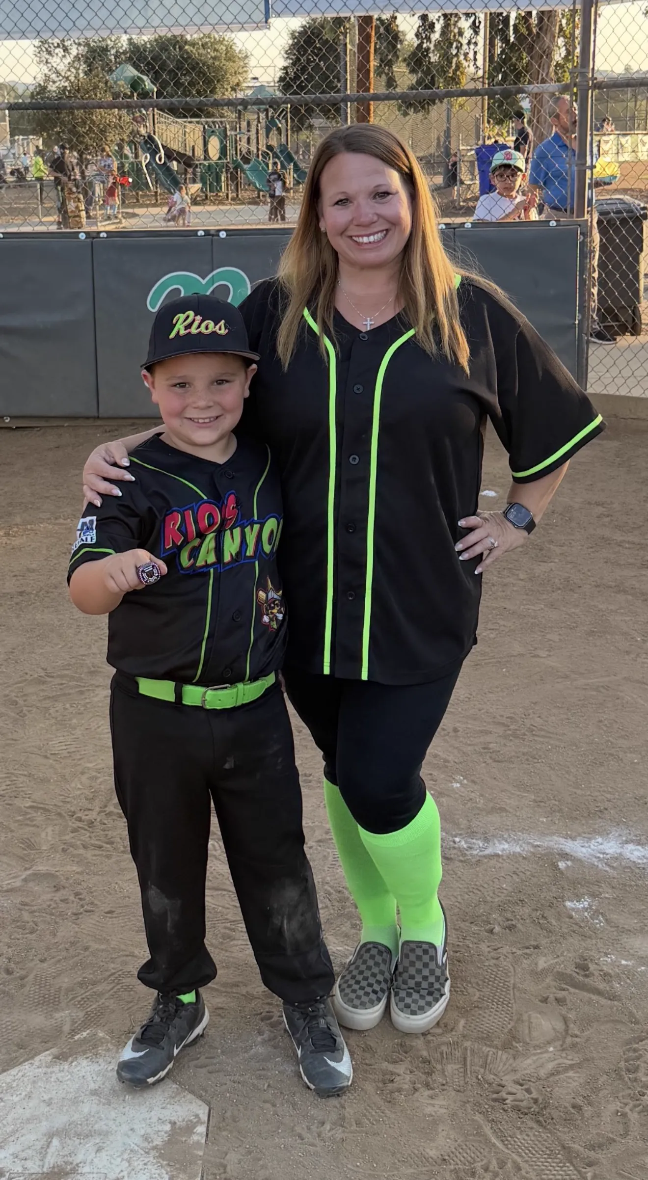 Charissa with a young ballplayer on the field